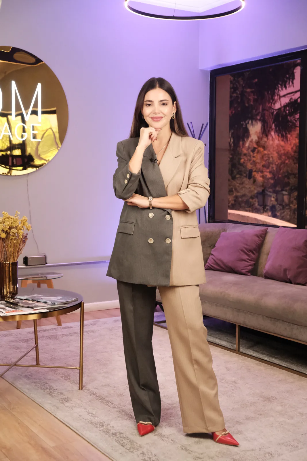 Daniela Mateluna de pie en el estudio de DM IMAGE, con un traje sastre bicolor